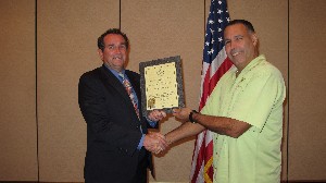 In October, Gabe Ruiz (r), president and owner of Advanced IT Concepts, receives a certificate of recognition from Steve Painter, chapter president, upon becoming an AFCEA corporate member.
